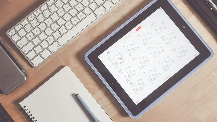Calendar on iPad by computer and notebook