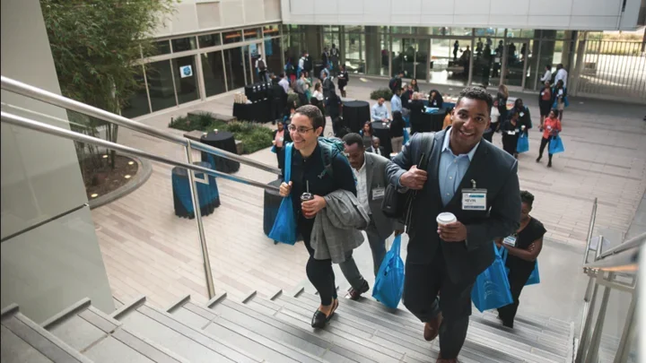 EDI conference break in Geffen Hall, participants walking up the stairs of the courtyard