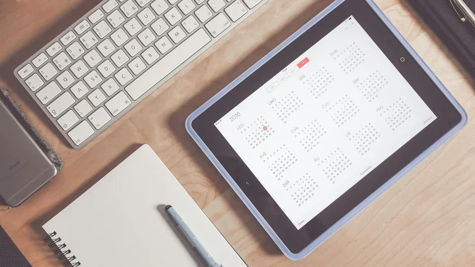 Calendar on iPad by computer and notebook