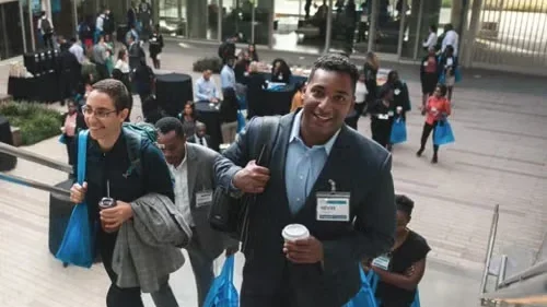 A group of people excitedly walking up stairs