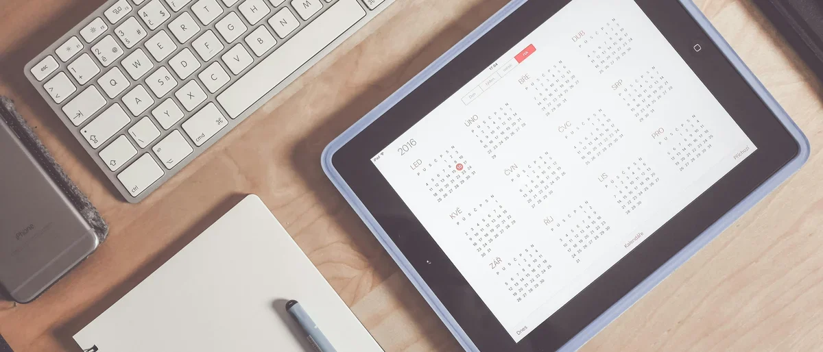Calendar on iPad by computer and notebook