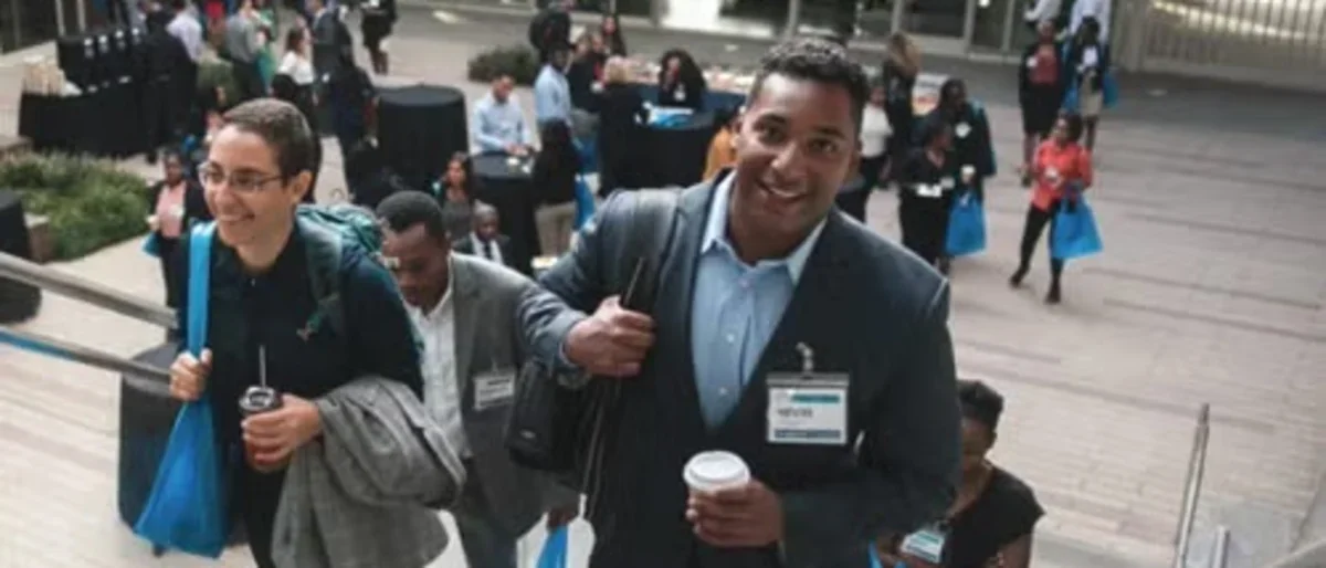 A group of people excitedly walking up stairs