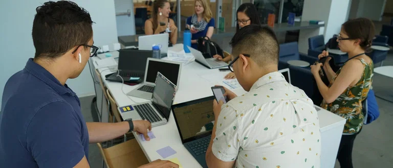 group of people working together at one table
