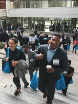 EDI conference break in Geffen Hall, participants walking up the stairs of the courtyard