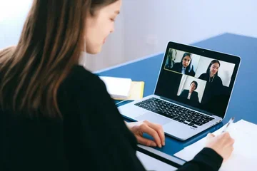 Woman on Zoom with other women