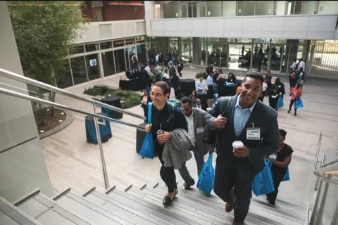 EDI conference break in Geffen Hall, participants walking up the stairs of the courtyard