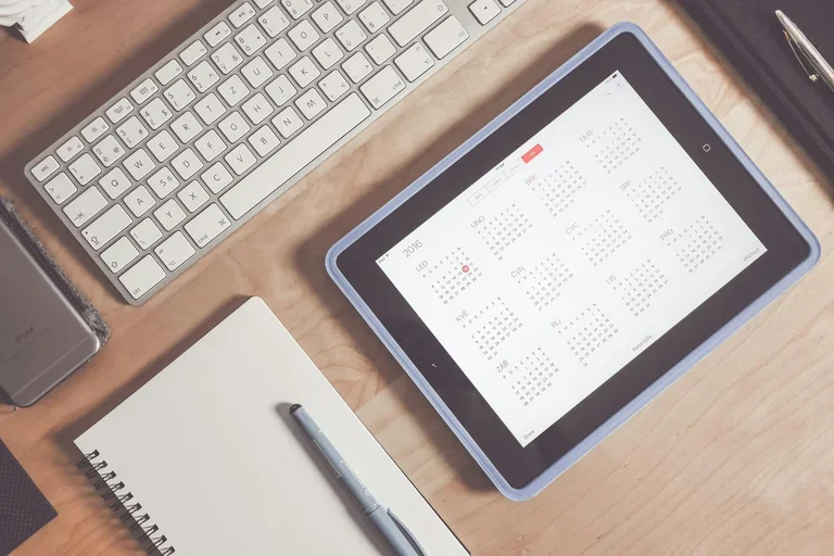 Calendar on iPad by computer and notebook