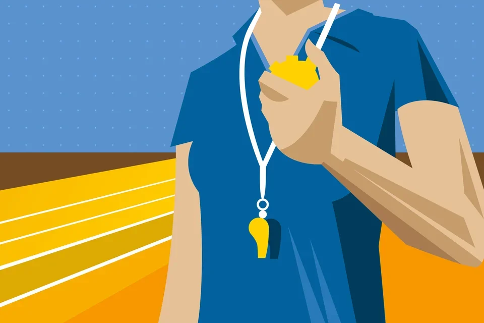 A person wearing a whistle and holding a timer on a race track