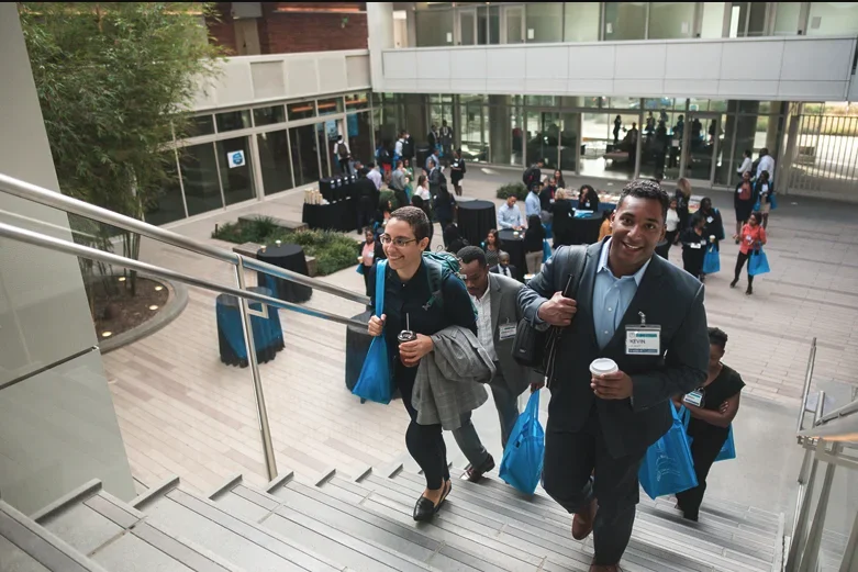 EDI conference break in Geffen Hall, participants walking up the stairs of the courtyard
