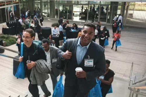 A group of people excitedly walking up stairs
