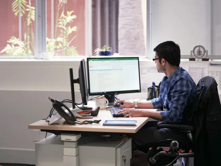 Man sitting at desk working on computer