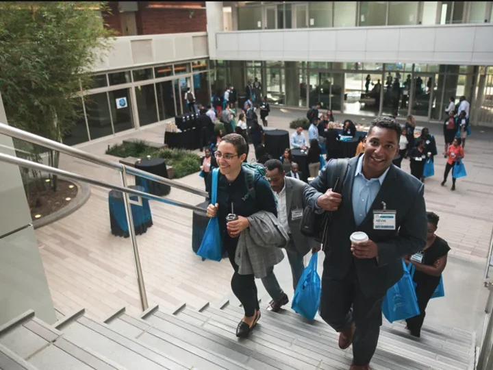 EDI conference break in Geffen Hall, participants walking up the stairs of the courtyard