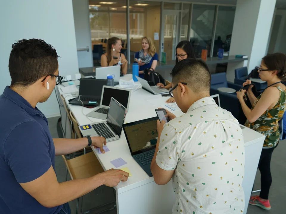 group of people working together at one table