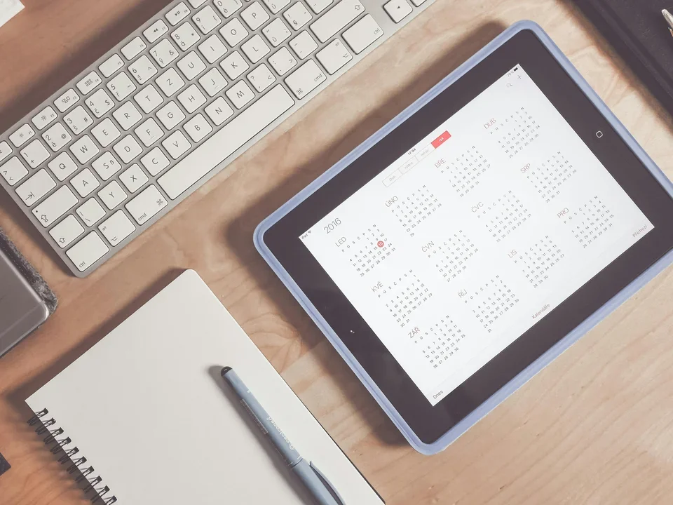 Calendar on iPad by computer and notebook