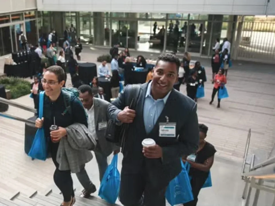 A group of people excitedly walking up stairs