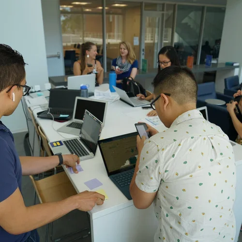 group of people working together at one table