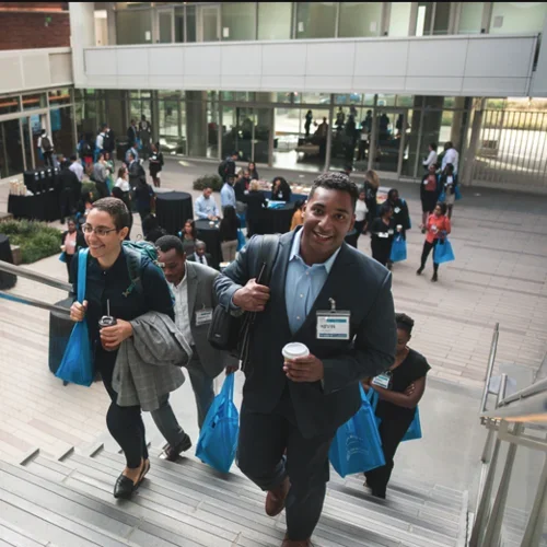 EDI conference break in Geffen Hall, participants walking up the stairs of the courtyard