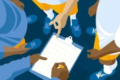 Three people staning in a circle looking down at a clipboard with a Quick Refrence guide